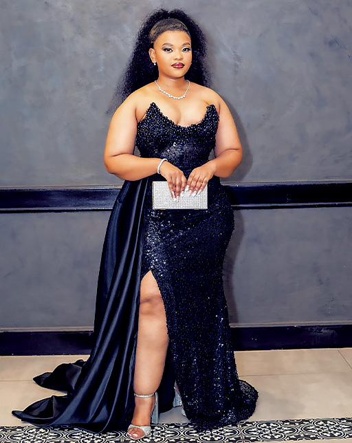 Posing for a picture in a black sequins dress